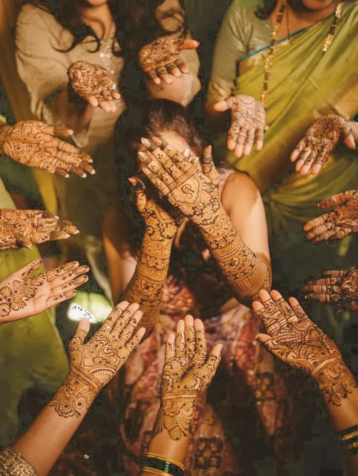 Intricate mehendi designs on wedding guests' hands
